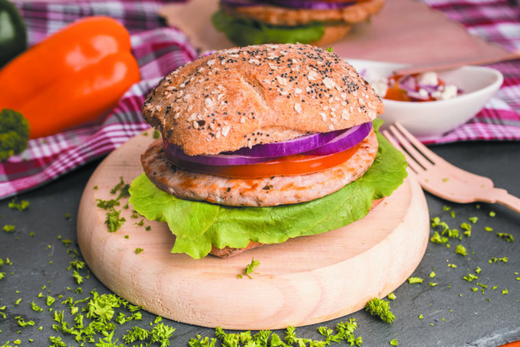 Hamburguesas de pollo sobre plato de madera